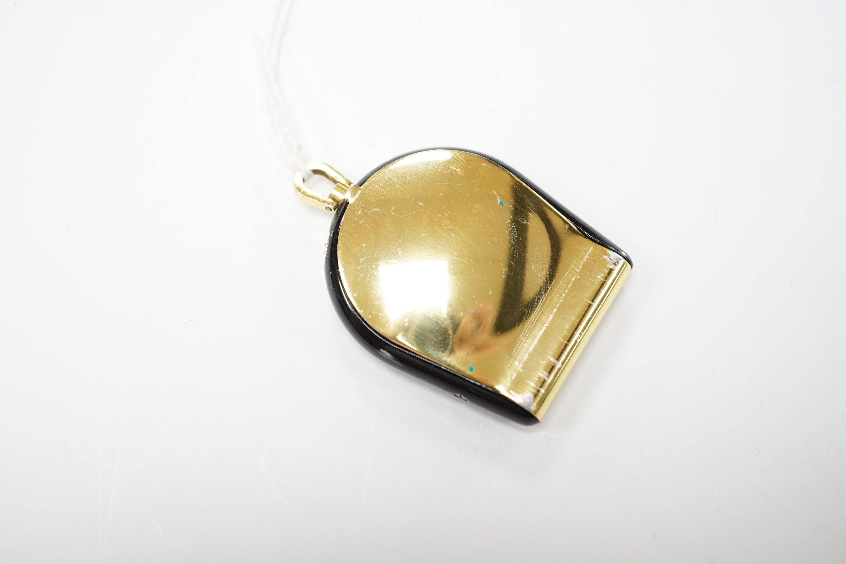 A gilt metal and black enamel Jaeger LeCoultre horseshoe shaped travelling timepiece, 45mm.